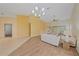 Open living space with wood and tile flooring, natural light, and neutral walls at 8382 Creekview Ln, Englewood, FL 34224