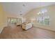 Inviting living room with vaulted ceiling, fan, sliding doors, and warm wood floors at 8382 Creekview Ln, Englewood, FL 34224