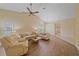 Bright living room featuring vaulted ceiling, lots of seating, wood flooring, and ample natural light at 8382 Creekview Ln, Englewood, FL 34224