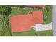 Aerial shot highlighting the terra cotta tile roof of the home and its manicured lawn at 8382 Creekview Ln, Englewood, FL 34224