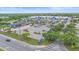 Aerial view of a shopping center with a Walmart and gas station, surrounded by lush greenery and ample parking at 8382 Creekview Ln, Englewood, FL 34224