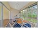 Inviting sunroom filled with natural light, providing a cozy seating area and views of the surrounding greenery at 8382 Creekview Ln, Englewood, FL 34224