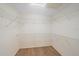 Unfinished walk-in closet with wire shelving, perfect for customization at 8382 Creekview Ln, Englewood, FL 34224