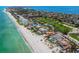 Aerial view of beachfront homes including manicured lawns, in a coastal community with beach access and ocean views at 845 Longboat Club Rd, Longboat Key, FL 34228