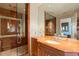 Elegant bathroom with marble finishes, glass shower and a decorative mirror providing an elegant, spa-like experience at 845 Longboat Club Rd, Longboat Key, FL 34228