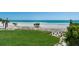 Scenic shot from property showing ocean views and direct beach access with lush landscaping creating a private oasis at 845 Longboat Club Rd, Longboat Key, FL 34228