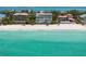 Beautiful beachfront home featuring lush landscaping, direct beach access, and ocean views at 845 Longboat Club Rd, Longboat Key, FL 34228