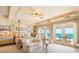 A luxurious primary bedroom has an ocean view, a decorative ceiling, and custom draperies at 845 Longboat Club Rd, Longboat Key, FL 34228