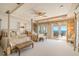 This primary bedroom has decorative ceilings, a ceiling fan, and direct balcony access at 845 Longboat Club Rd, Longboat Key, FL 34228