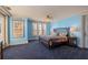 Comfortable blue bedroom with carpet, shutters, ceiling fan, and accent lighting at 845 Longboat Club Rd, Longboat Key, FL 34228