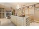 Large walk-in closet featuring ample storage, custom cabinetry, and chandelier, offering both style and functionality at 845 Longboat Club Rd, Longboat Key, FL 34228