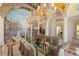 A stunning formal dining room with a mural and elegant chandelier at 845 Longboat Club Rd, Longboat Key, FL 34228