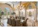 An opulent dining room featuring a muraled ceiling and elegant chandeliers at 845 Longboat Club Rd, Longboat Key, FL 34228