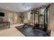 Spacious exercise room with weight training equipment, bright lighting, ceiling fan, tiled floors and French doors at 845 Longboat Club Rd, Longboat Key, FL 34228