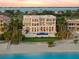 Elegant beachfront home featuring multiple balconies, a pool, lush landscaping and direct beach access at 845 Longboat Club Rd, Longboat Key, FL 34228