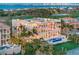 Beautiful multi-story home featuring expansive balconies, a pool, manicured lawns, and tropical landscaping at 845 Longboat Club Rd, Longboat Key, FL 34228