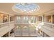 Two-story foyer with soaring ceilings, large windows and marble floors with decorative inlay at 845 Longboat Club Rd, Longboat Key, FL 34228