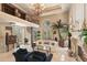 A charming living room with a spiral staircase and a cozy fireplace at 845 Longboat Club Rd, Longboat Key, FL 34228