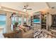 Cozy living room featuring custom built-ins, a wet bar, and balcony access at 845 Longboat Club Rd, Longboat Key, FL 34228