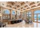 An elegant living room with coffered ceilings, arched windows, and stunning ocean views at 845 Longboat Club Rd, Longboat Key, FL 34228