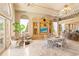 Spacious living room with ornate millwork, chandeliers, comfortable seating and ocean view, perfect for entertaining guests at 845 Longboat Club Rd, Longboat Key, FL 34228