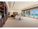 Elegant bedroom featuring a spacious layout, large built-in bookshelf, and a private balcony with ocean views at 845 Longboat Club Rd, Longboat Key, FL 34228