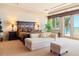 Serene bedroom featuring refined decor, private sitting area, and a captivating ocean view fostering a relaxing ambiance at 845 Longboat Club Rd, Longboat Key, FL 34228