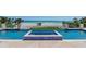 Stunning pool with a beach view, a spa, and glass railings at 845 Longboat Club Rd, Longboat Key, FL 34228
