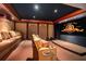 Home movie theatre with a large screen, a projector, and tiered seating at 845 Longboat Club Rd, Longboat Key, FL 34228