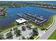 Aerial view of boat docks featuring a large lake, parking, and a small white building at 850 Tidewater Shores Loop # 108, Bradenton, FL 34208
