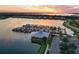 Aerial view of community with lake, boat docks, and well-maintained residences at sunset at 850 Tidewater Shores Loop # 108, Bradenton, FL 34208