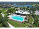 Community aerial view showcasing a pool, clubhouse, and surrounding landscape at 850 Tidewater Shores Loop # 108, Bradenton, FL 34208