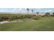 Lush backyard with mature trees and vegetation offers a private oasis at 850 Tidewater Shores Loop # 108, Bradenton, FL 34208