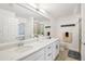 Bright bathroom features double sinks, white cabinets, and tile flooring at 850 Tidewater Shores Loop # 108, Bradenton, FL 34208