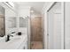 Well-lit bathroom featuring white vanity, quartz counters, and glass enclosed shower at 850 Tidewater Shores Loop # 108, Bradenton, FL 34208