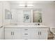Bright bathroom features double sinks, white cabinets, and tile shower at 850 Tidewater Shores Loop # 108, Bradenton, FL 34208