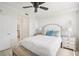 Bright bedroom with a king bed, white linens, a ceiling fan, and a glimpse into the en-suite bathroom at 850 Tidewater Shores Loop # 108, Bradenton, FL 34208