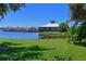 Lakeside view of the community docks and building with well-manicured lawn at 850 Tidewater Shores Loop # 108, Bradenton, FL 34208