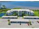 Condo exterior featuring covered parking, lush landscaping, and tranquil waterfront views at 850 Tidewater Shores Loop # 108, Bradenton, FL 34208