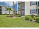 Building exterior featuring a screened-in porch and well-maintained landscaping, perfect for enjoying the outdoors at 850 Tidewater Shores Loop # 108, Bradenton, FL 34208