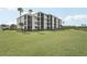 Multi-story condo building with private lanais surrounded by a green lawn at 850 Tidewater Shores Loop # 108, Bradenton, FL 34208