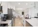 Modern kitchen featuring stainless steel appliances, a bright dining area, white cabinets and white quartz countertops at 850 Tidewater Shores Loop # 108, Bradenton, FL 34208