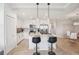 Bright kitchen with white cabinetry, stainless steel appliances, a center island with seating and modern pendant lighting at 850 Tidewater Shores Loop # 108, Bradenton, FL 34208