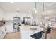 A modern, well-lit kitchen with stainless steel appliances, white cabinetry, and eat in island at 850 Tidewater Shores Loop # 108, Bradenton, FL 34208