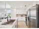 A modern kitchen features stainless steel appliances, white cabinets, and stylish countertops at 850 Tidewater Shores Loop # 108, Bradenton, FL 34208
