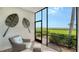 Inviting screened lanai features comfortable seating and peaceful water views at 850 Tidewater Shores Loop # 108, Bradenton, FL 34208
