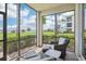 Serene screened lanai with comfortable seating area and picturesque water views at 850 Tidewater Shores Loop # 108, Bradenton, FL 34208