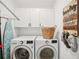 Well-lit laundry room featuring modern washer and dryer with white cabinets above for storage at 850 Tidewater Shores Loop # 108, Bradenton, FL 34208