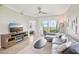 Inviting living room boasting neutral tones, a modern ceiling fan, and scenic views at 850 Tidewater Shores Loop # 108, Bradenton, FL 34208
