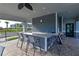 Outdoor kitchen with bar seating for entertaining with views of the pool and surrounding community at 850 Tidewater Shores Loop # 108, Bradenton, FL 34208